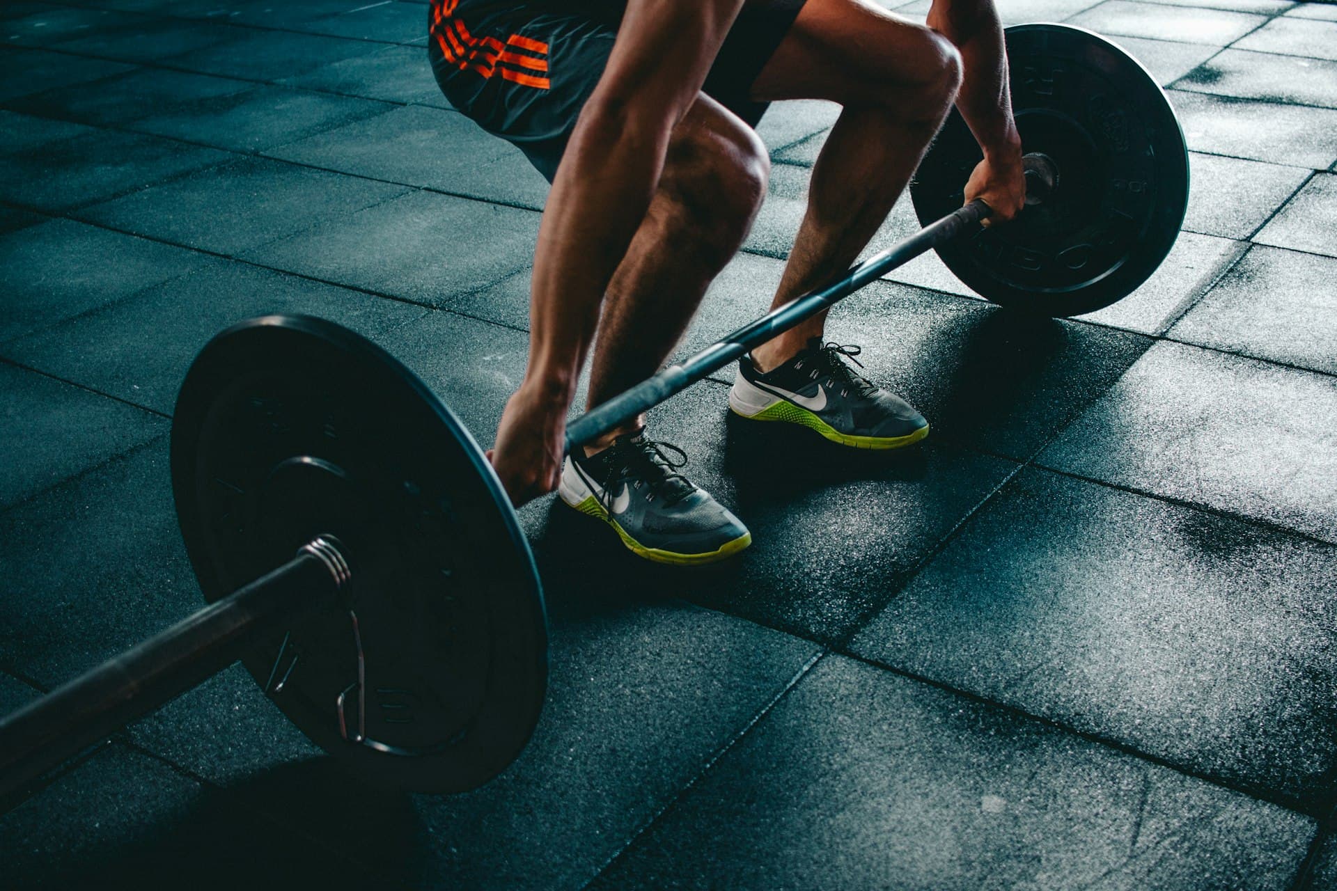 Athlete mid-lift under dramatic gym lighting